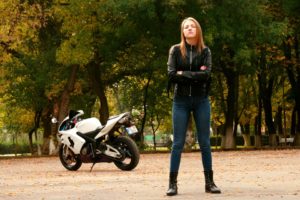 Girl posing with her motorcycle.